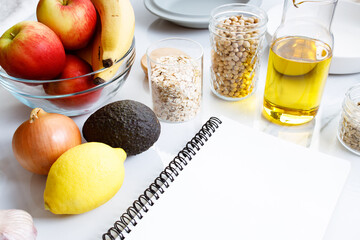 Culinary, cooking and healthy food concept. Food ingredients on table with notebook