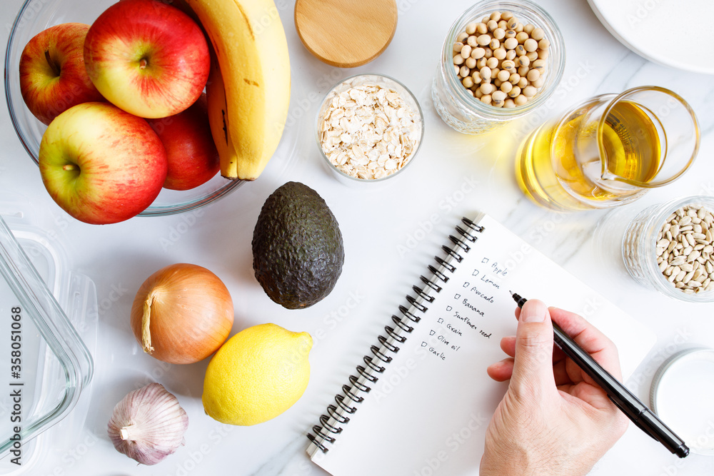 Wall mural culinary, cooking and healthy food concept. food ingredients on table with notebook