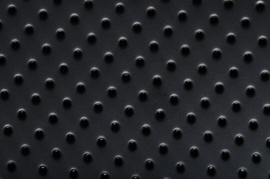 Black plastic surface with dots © PixieMe