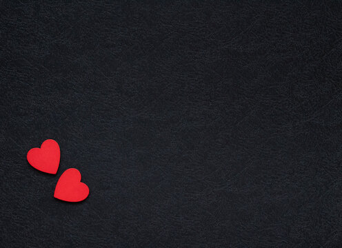Fototapeta two red hearts in the corner of black background. Concept of love. Valentine's day background.
