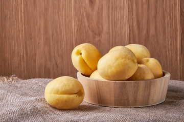 fresh apricots in a Cup on a wooden table