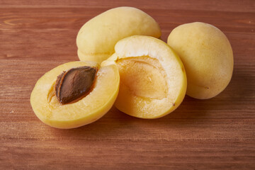 fresh apricots in a Cup on a wooden table