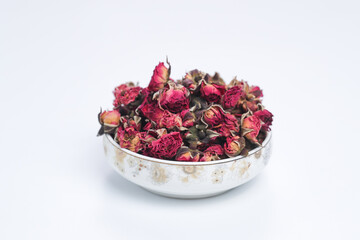 A heap of rose heads for making tea on white background