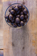 Black olives in a glass.