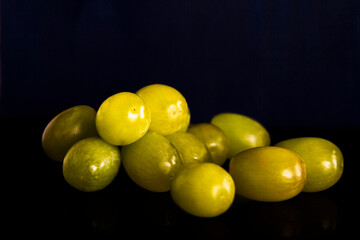Green grapes on black background