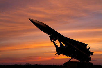 silhouette of an air defense missile against the background of dawn