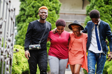 Four african friends having fun outdoors. Two black girls with guys.