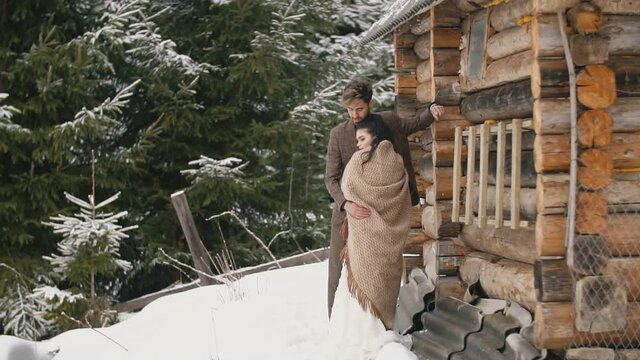 couple near a wooden house