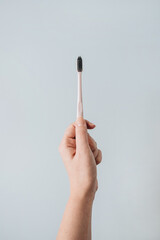 Woman's hand hold toothbrush on blue background. Flat lay, top view oral care, dental hygiene concept.