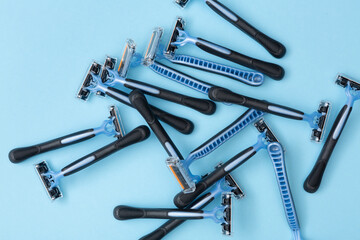 razor blades piled on a blue background
