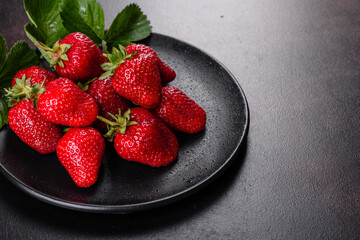Beautiful juicy fresh strawberries on the concrete surface of the table