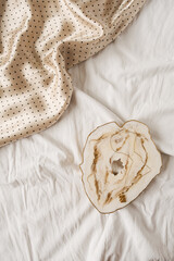 Marble tray and silk polka-bot cloth on white linen. Minimal  fashion flat lay, top view composition.