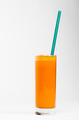 Apple juice in glass with blue green straw