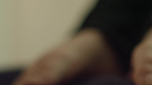 Close up of a woman moving her feet anxiously on the bed