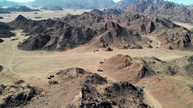 Top view of the Sahara desert, desert mountains. Wooden Bedouin houses. Sands.