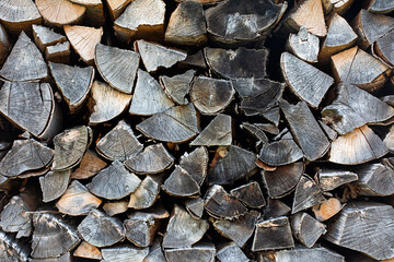 Pieces of gray firewood stacked up.