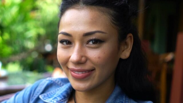 Portrait of happy, beautiful asian woman sitting in cafe