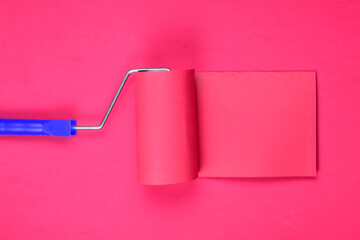 Paint utensil on pink background, space for text