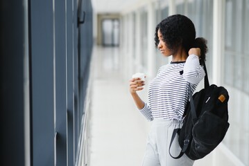 African student girl in university corridor. Obtaining professional education.