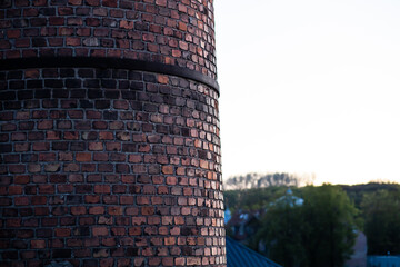 Close up view of an old masonry chimney in the evening.