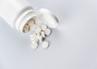 white calcium pills on a white background