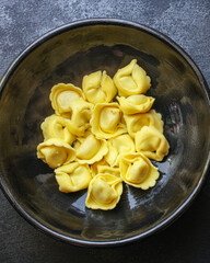 tortellini pasta stuffed ravioli serving size. food background top view copy space for text