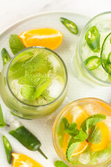 three glasses with drinks with ice and mint top view.
