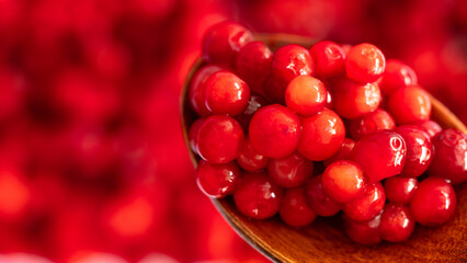 Cranberry placed in a wooden spoon and placed on a wooden floor,  Red sour fruit  There are many health benefits.
