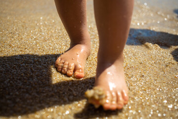 toddler baby feet on the sand beach. Vacation and travel with small children concept