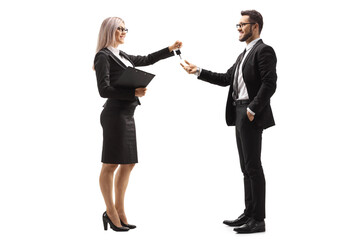 Professional woman giving car keys to a businessman