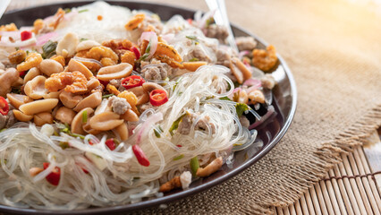 Glass Noodle,Pork,Nut Spicy Salad
(Yum Woon Sen)  Full of fried beans and dried shrimp in  plate.