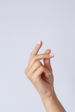 Gesture and sign, female hand on a white background. hand click or snapping fingers