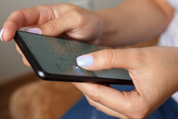 girl holding a smartphone in her hands. Phone display close up
