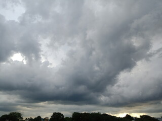 Bright glowing clouds on the black sky on sunset.