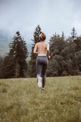 Woman running in nature. Sport, jogging, healthy lifestyle concept