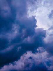 Obraz premium Bright glowing clouds on the blue sky on sunset.