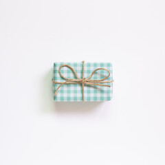 Green check pattern gift box isolated on white background. top view, copy space