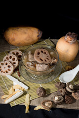 Lotus root soup with beans in a bowl and Chinese herbs, shiitake mushroom, lotus root