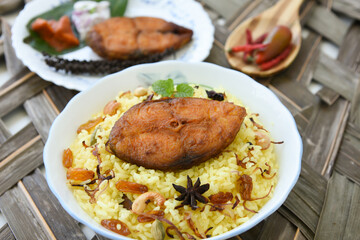 Fish biryani. Spicy and delicious Malabar biryani or Hydrabadi  biryani, Dum Biriyani,  pulao basmati rice, herbs, raitha for Ramadan Kareem, Eid