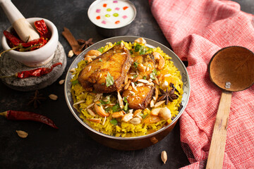 Fish biryani. Spicy and delicious Malabar biryani or Hydrabadi  biryani, Dum Biriyani,  pulao basmati rice, herbs, raitha for Ramadan Kareem, Eid