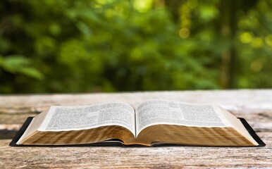 Open vintage christian bible on desk