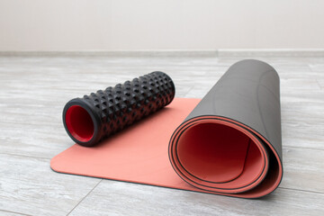 Foam roller and yoga mat in living room for meditation yoga