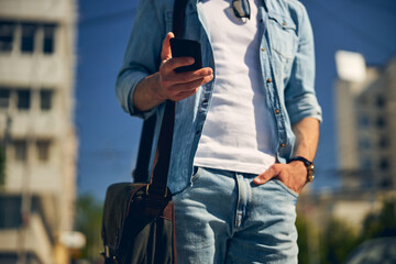 Close up of male hand that holding telephone