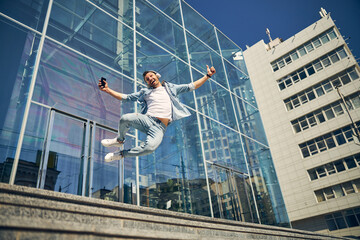 Happy man demonstrating his physical skills on camera