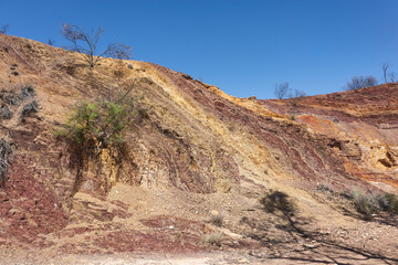 Ochre mine, used by aboriginal Australian as raw material for paintings and ceremonial body decoration. No clouds, clean sky. Ochre Pits, MacDonnell ranges, Northern Territory NT, Australia, Oceania