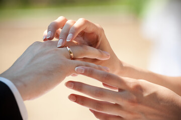 Wedding ceremony, the bride puts the ring on the groom's finger