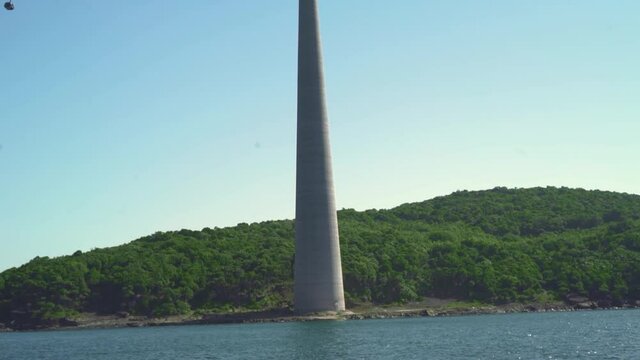 Aerial ropeway transit in Phu Quoc Vietnam tropical island with scenic view. Cable car ride in Vietnam is the longest ride in the world. View from the boat, the pylone of ART standing on the coast.