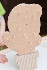 DIY toys. Corrugated cardboard cactus with wooden toothpick spikes. Montessori methodology tool on concentration and fine motor measurement. 5 minute crafts, easy game ideas. Montessori methodology.