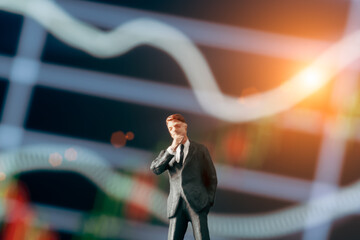 Concept of thinking businessman: Businessman figurine with  hand on cheek and deciding to make a...