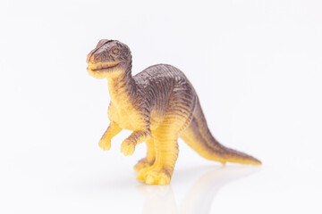close-up of a colorfull plastic dinosaur figurine isolated on a white background